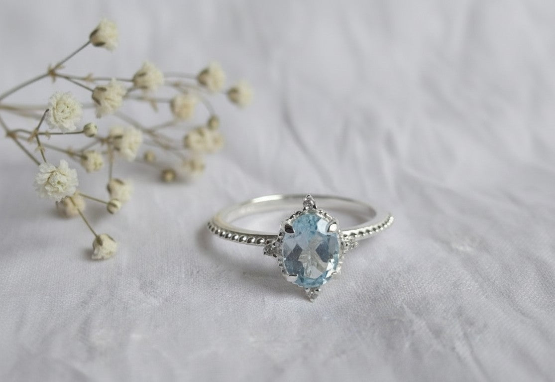 Whispers of the Ocean Ring: Natural Blue Topaz with Dazzling Moissanite Halo
