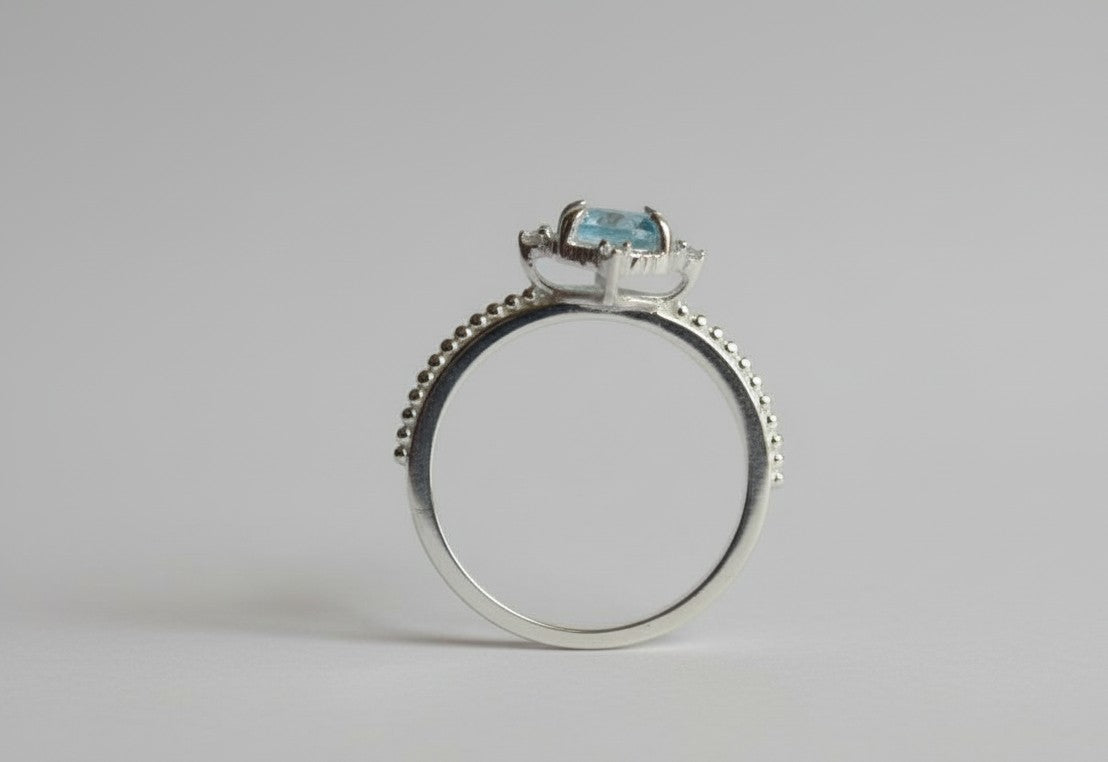 Whispers of the Ocean Ring: Natural Blue Topaz with Dazzling Moissanite Halo